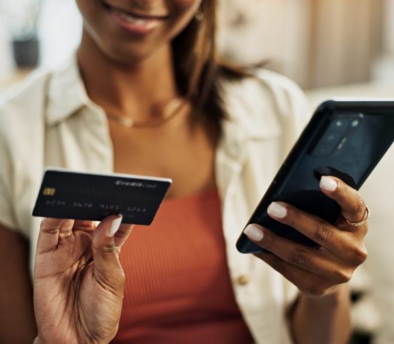 Hands, credit card and phone for closeup, person or reading with cybersecurity, fintech app or bank info in home. Woman, smartphone and payment for password, budget and discount on e commerce website